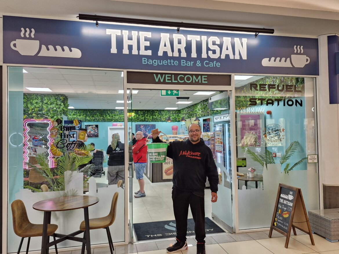 EJ stood outside The Artisan coffee shop